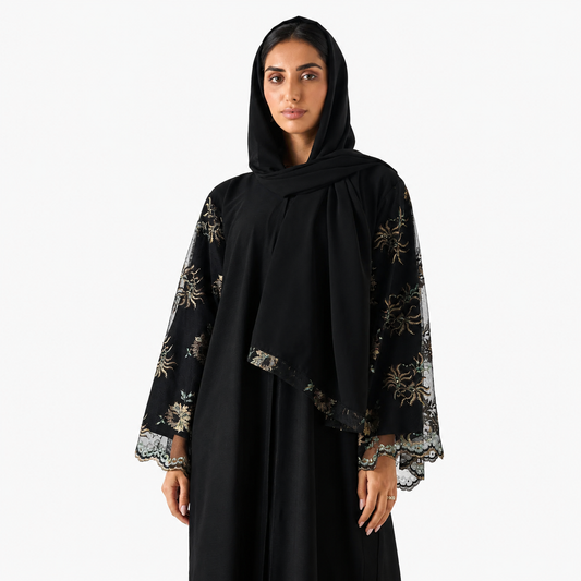 Close-up of intricate lace embroidery on black abaya