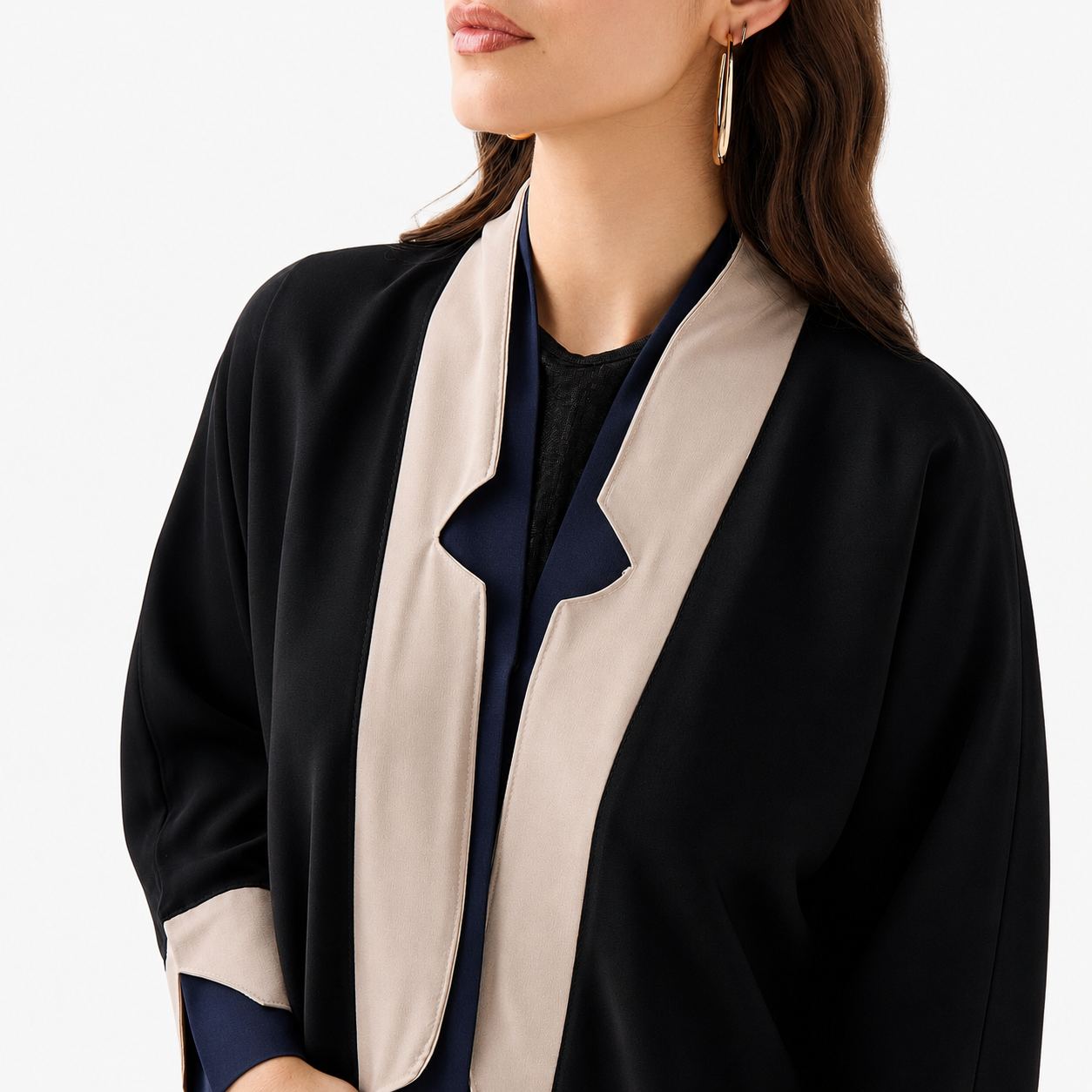 Close-up of beige and blue collar detail on black abaya