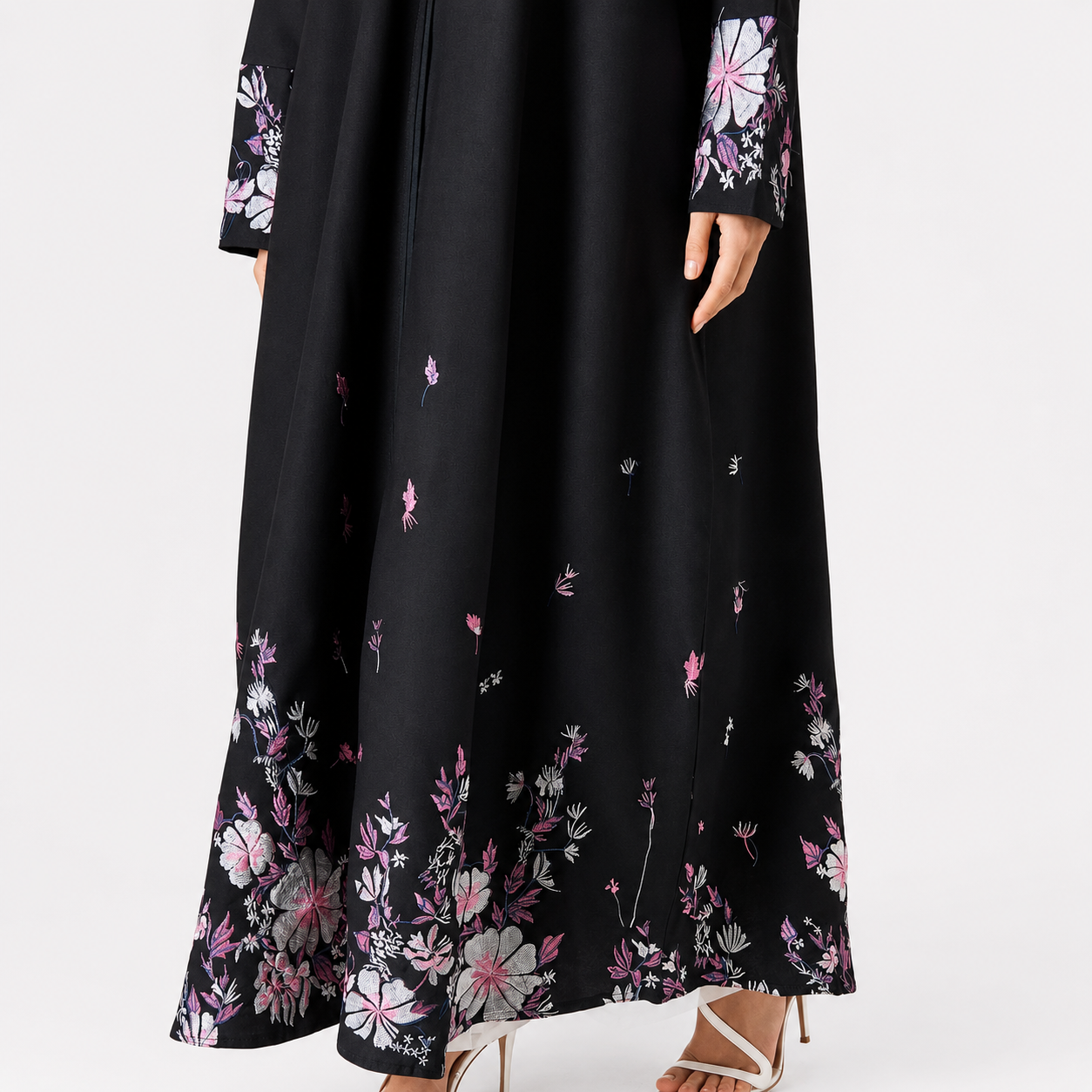Close-up of floral embroidery on black abaya hem