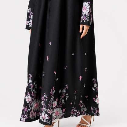 Close-up of floral embroidery on black abaya hem