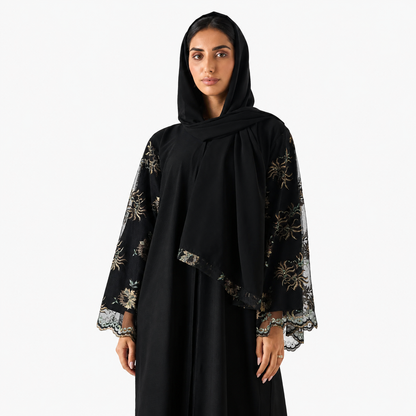 Close-up of intricate lace embroidery on black abaya