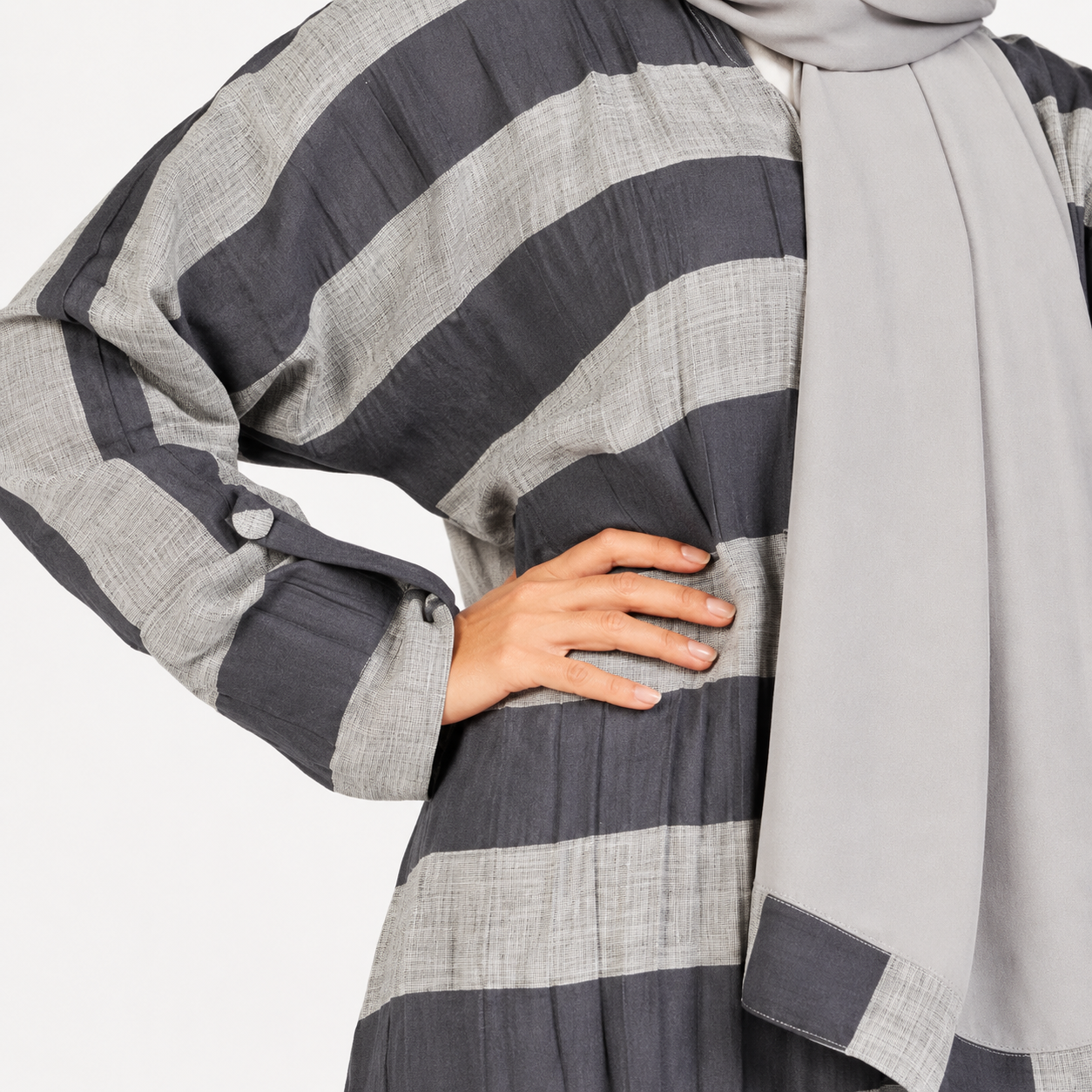 Crinkle fabric texture detail on grey striped abaya