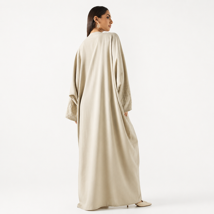 Back view of beige pearl-embellished bisht abaya