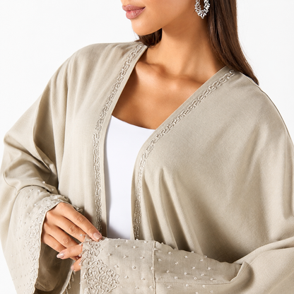 Side view of beige pearl bisht abaya flowing silhouette