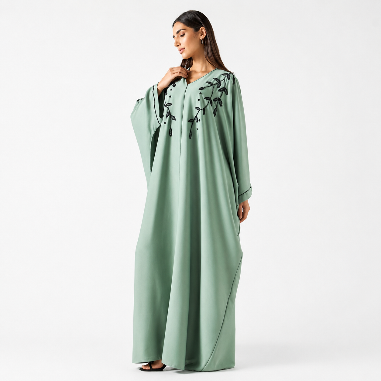 Side view of sage green bisht abaya with flowing silhouette