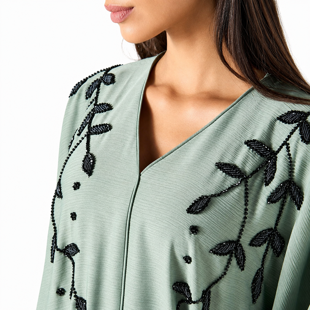 V-neckline detail on sage green satin abaya