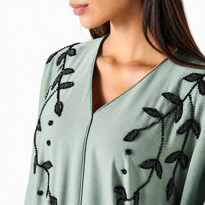 V-neckline detail on sage green satin abaya